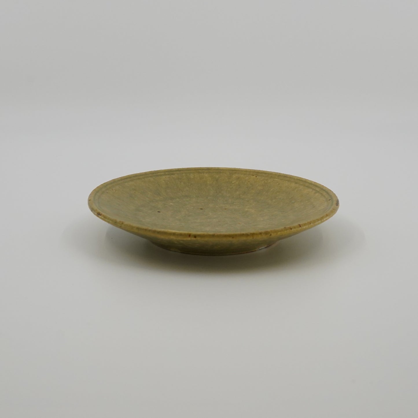 Ash color ceramic plate on a white background