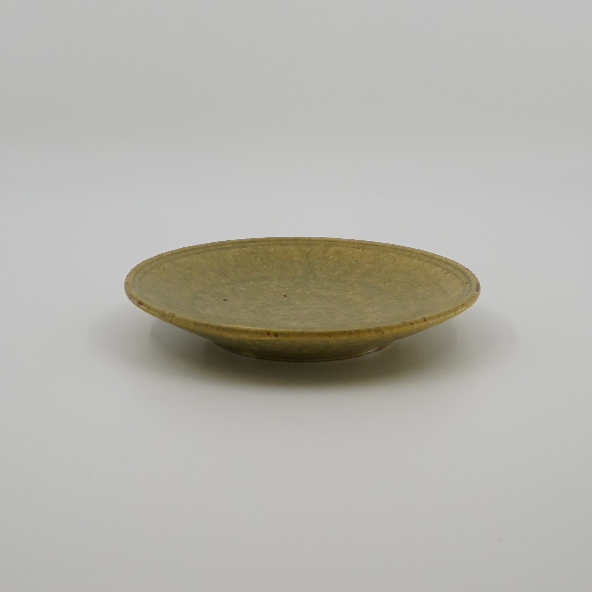 Ash color ceramic plate on a white background