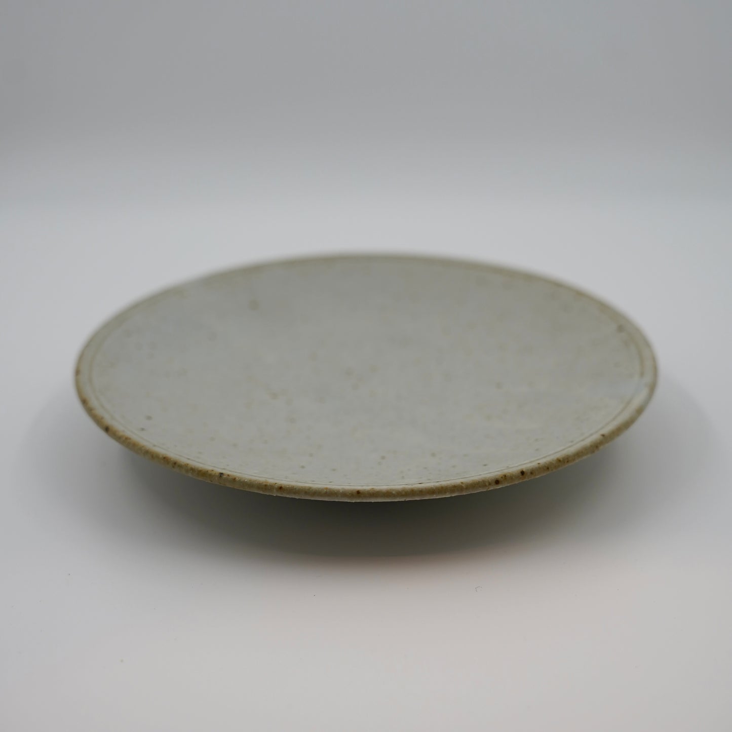 Round ceramic plate on a white background