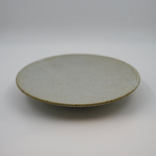 Round ceramic plate on a white background
