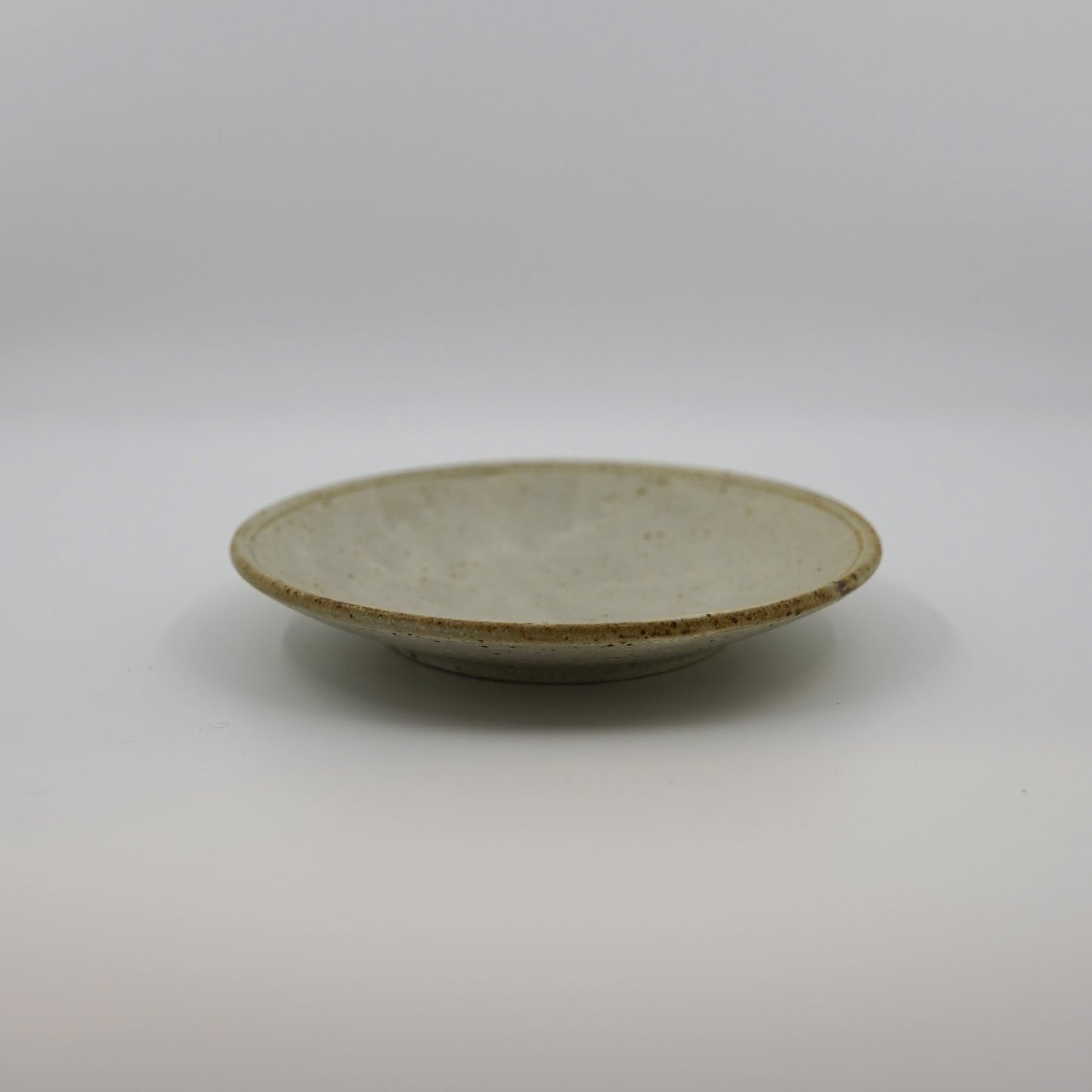 Small ceramic plate on a plain background