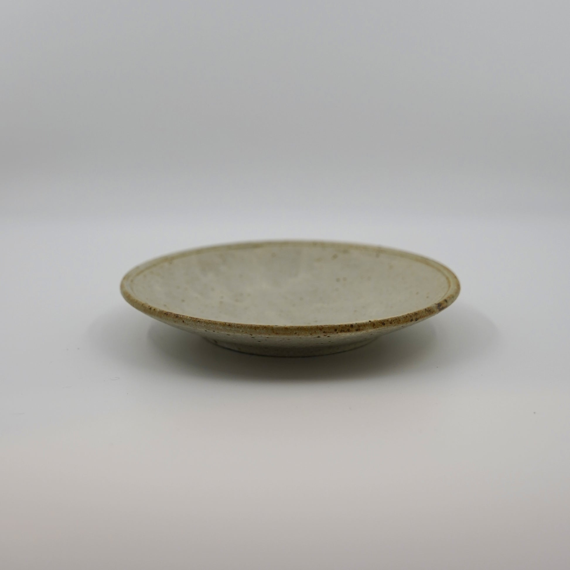 Small ceramic plate on a plain background