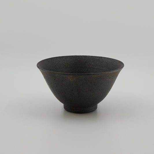 Black ceramic bowl on a light gray background