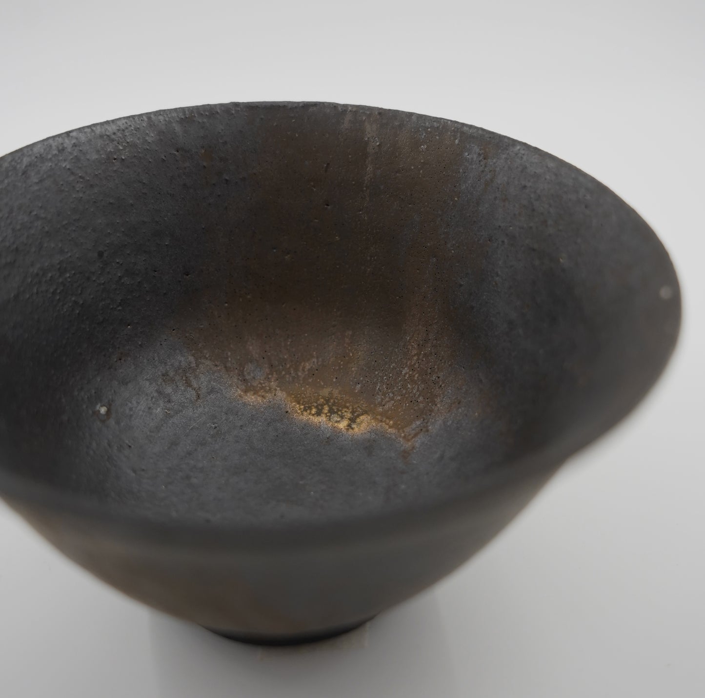 Black ceramic bowl on a white background
