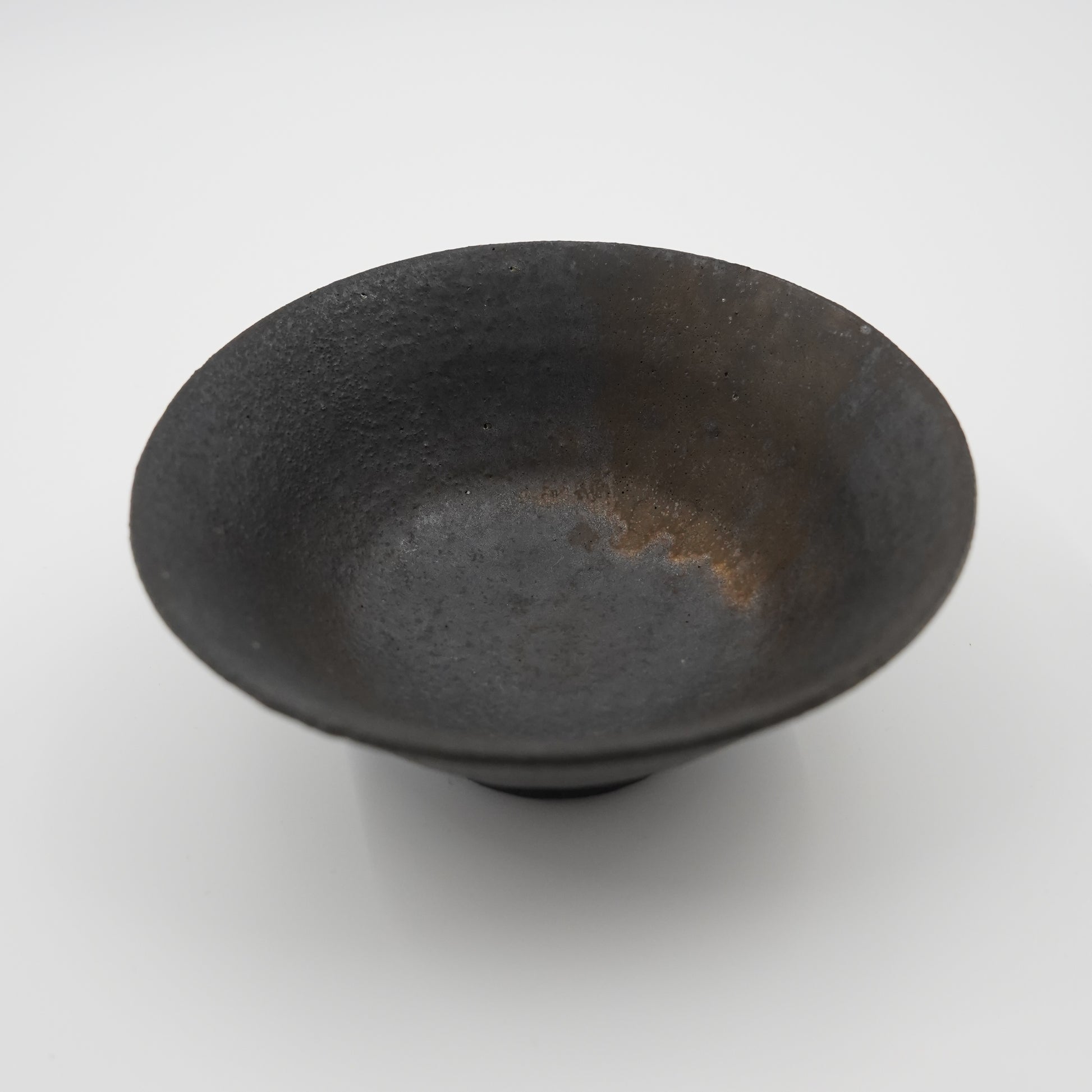 Black ceramic bowl on a white background