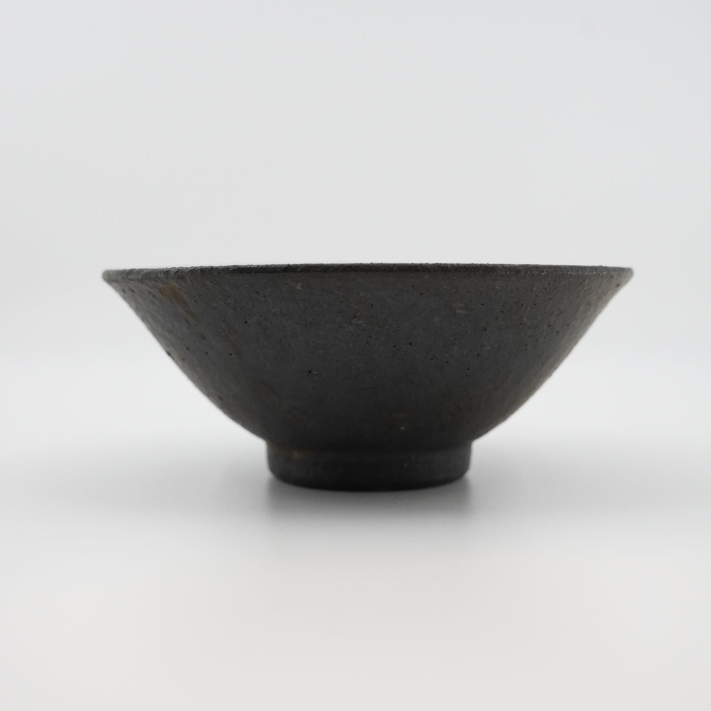 Black ceramic bowl on a white background