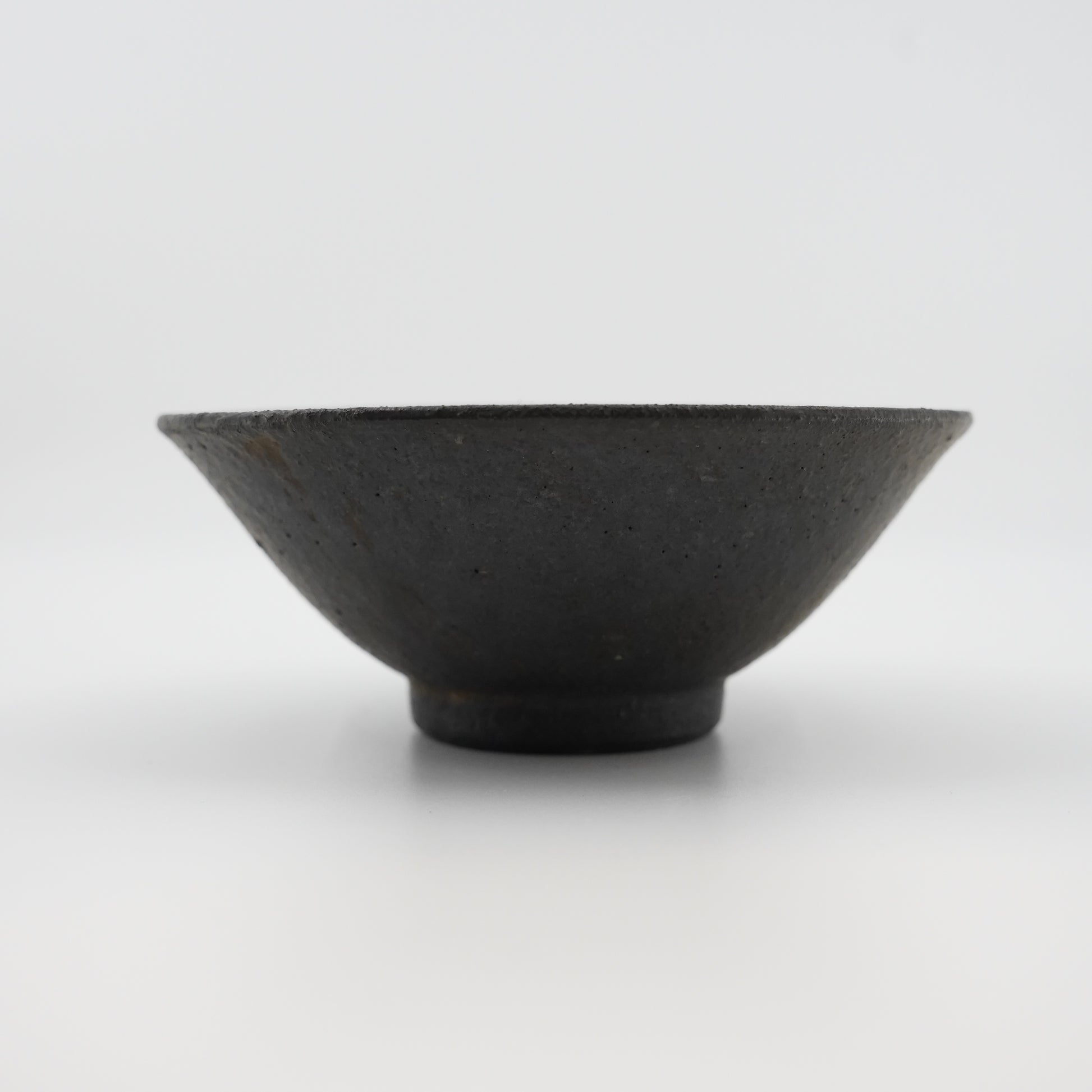 Black ceramic bowl on a white background
