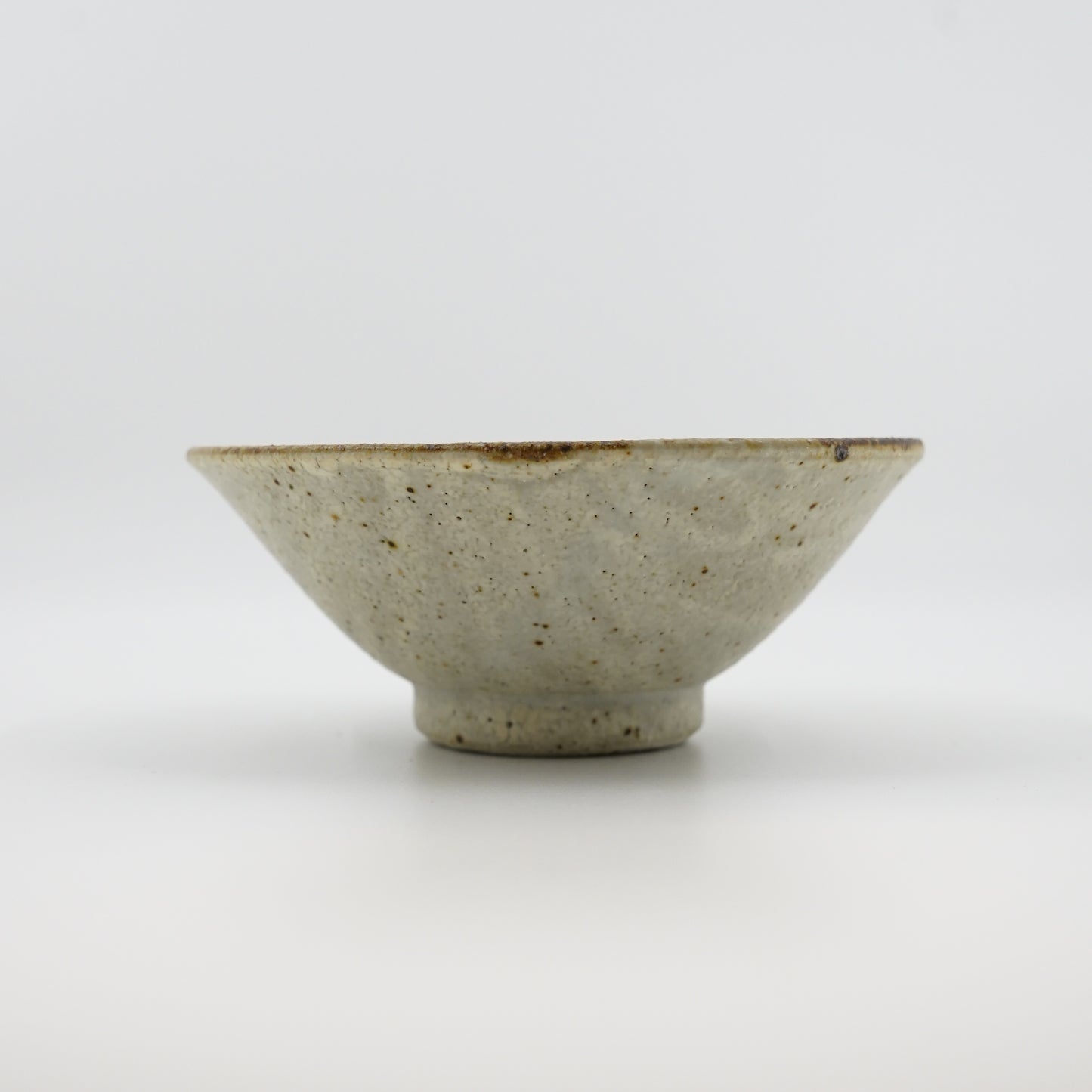 Ceramic bowl with a textured surface on a white background