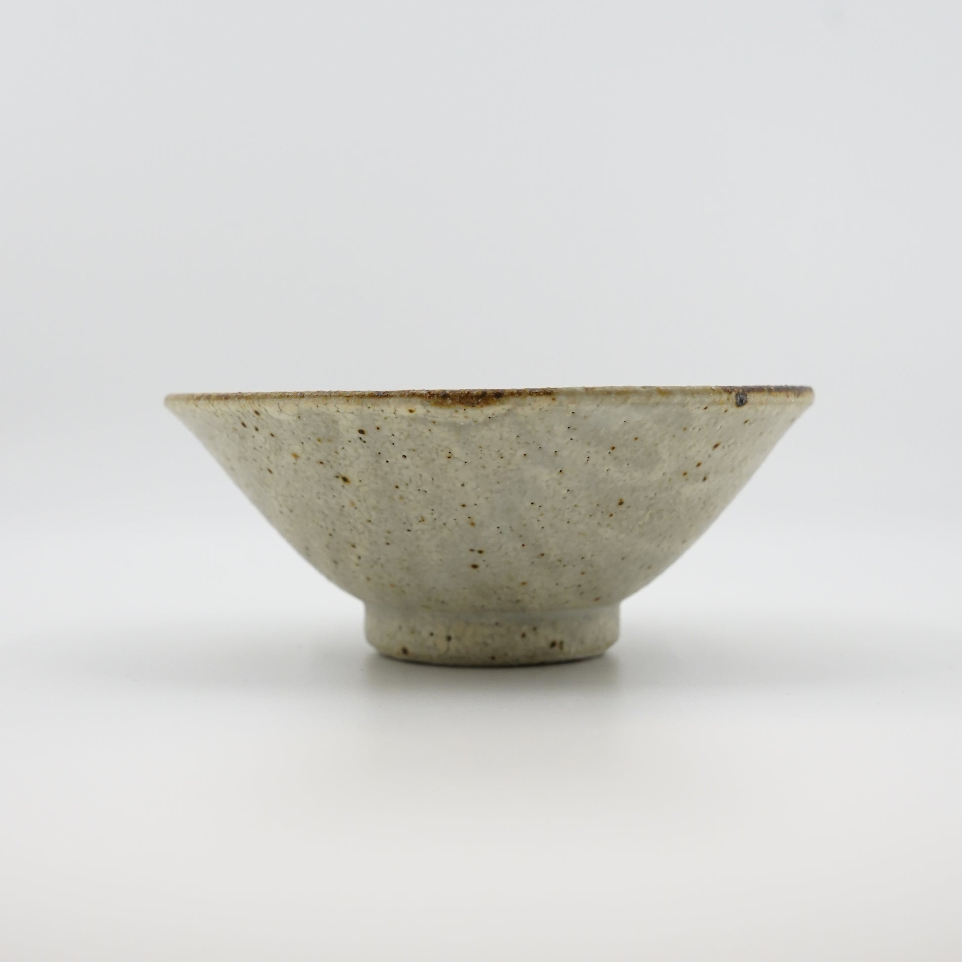 Ceramic bowl with a textured surface on a white background
