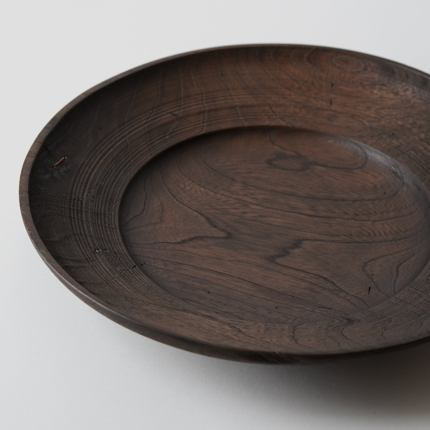 Wooden tray with engraved design on a white background