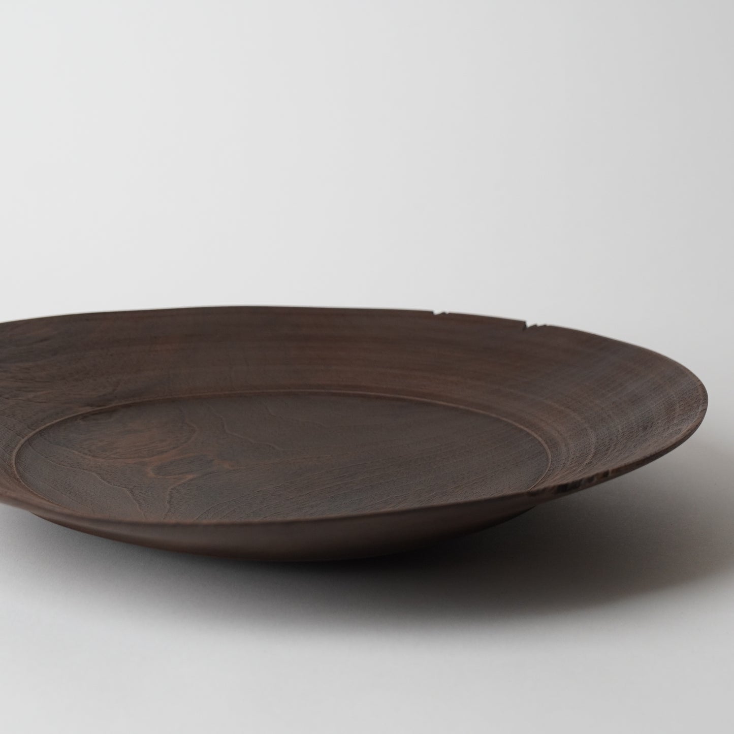 Brown ceramic plate on a light gray background