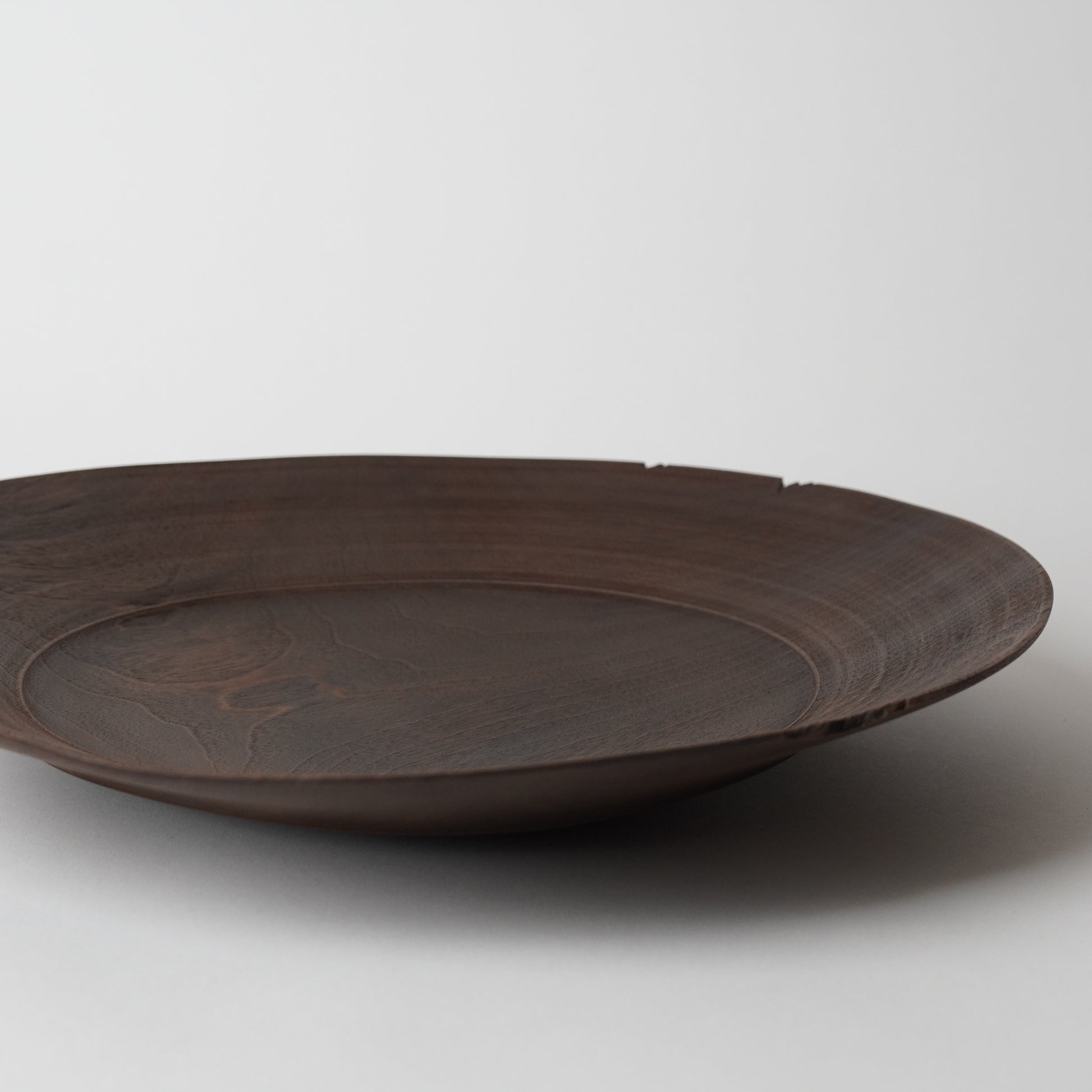 Brown ceramic plate on a light gray background
