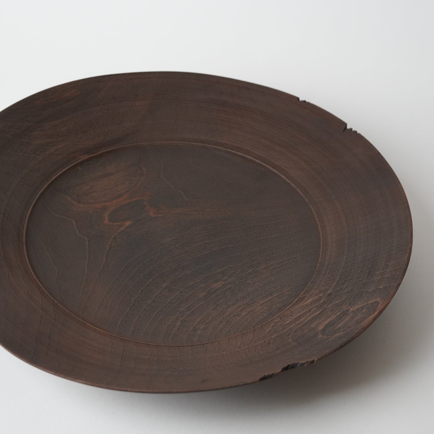 Wooden plate with a textured surface on a white background
