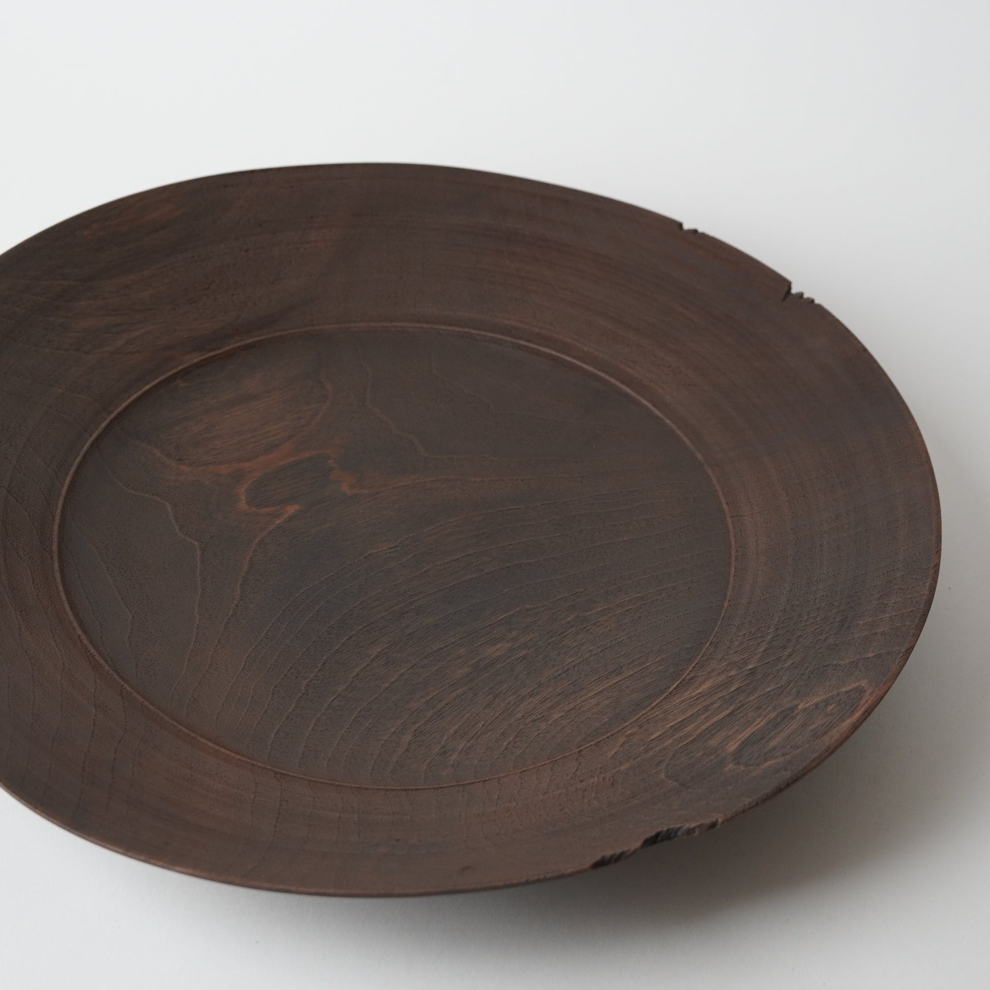 Wooden plate with a textured surface on a white background