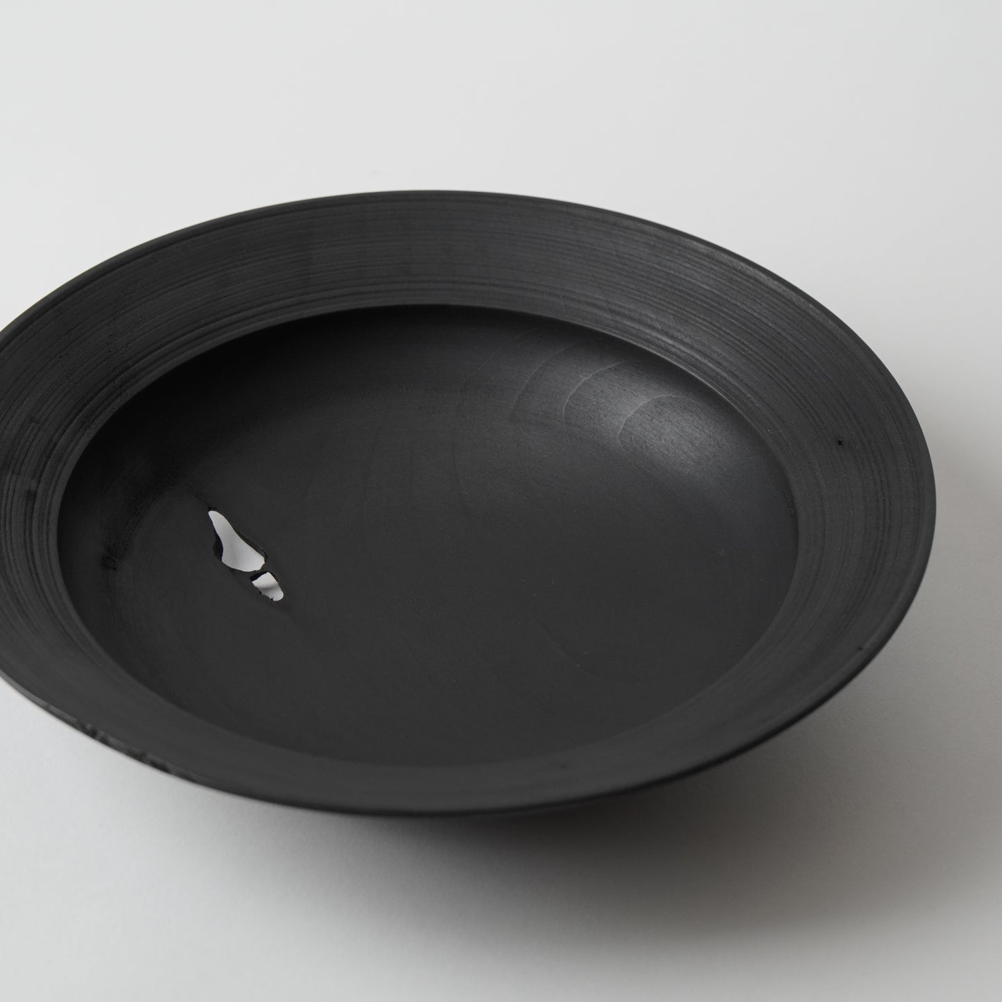 Black wooden plate on a white background