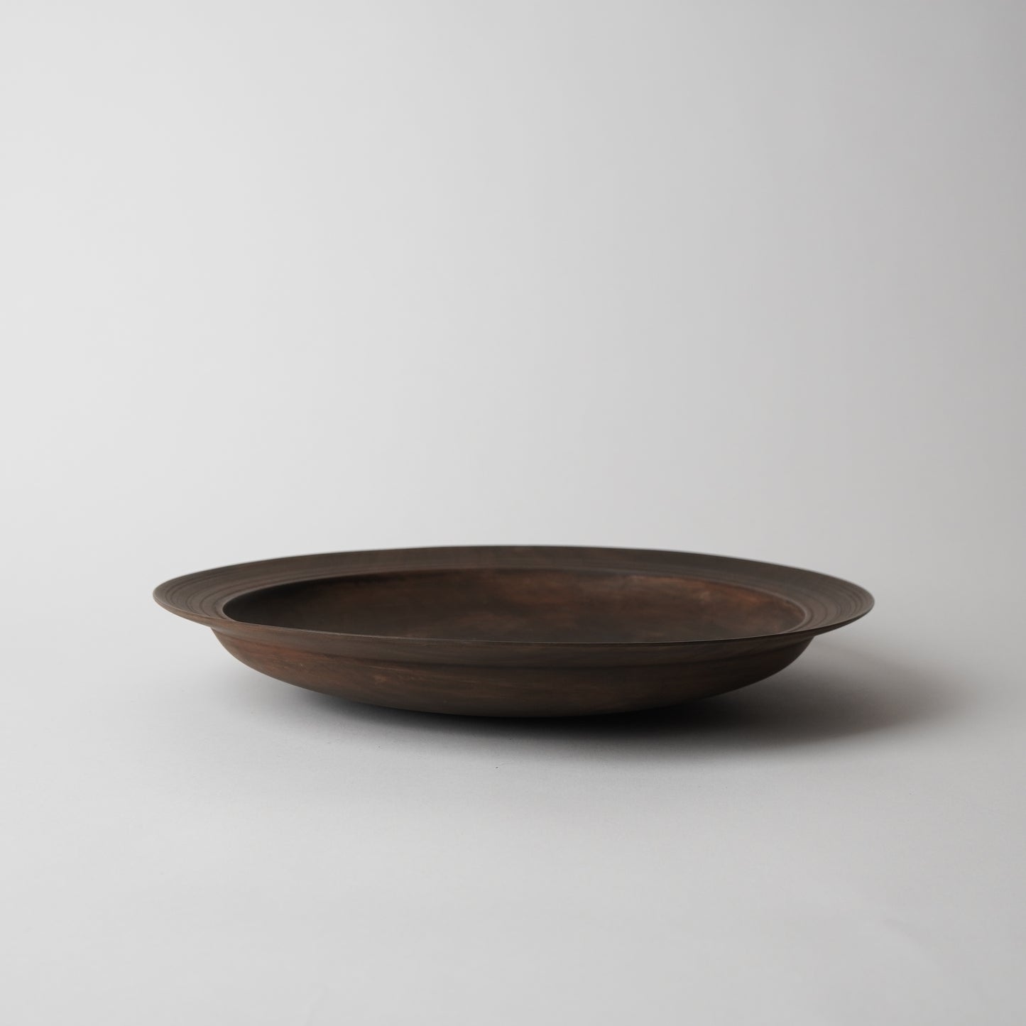 Bronze tray on a light gray background