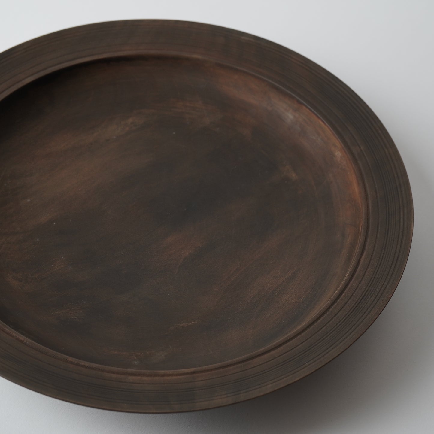 Dark wooden tray on a white background