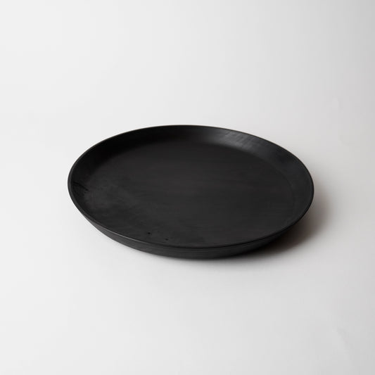 Black wooden plate on a white background