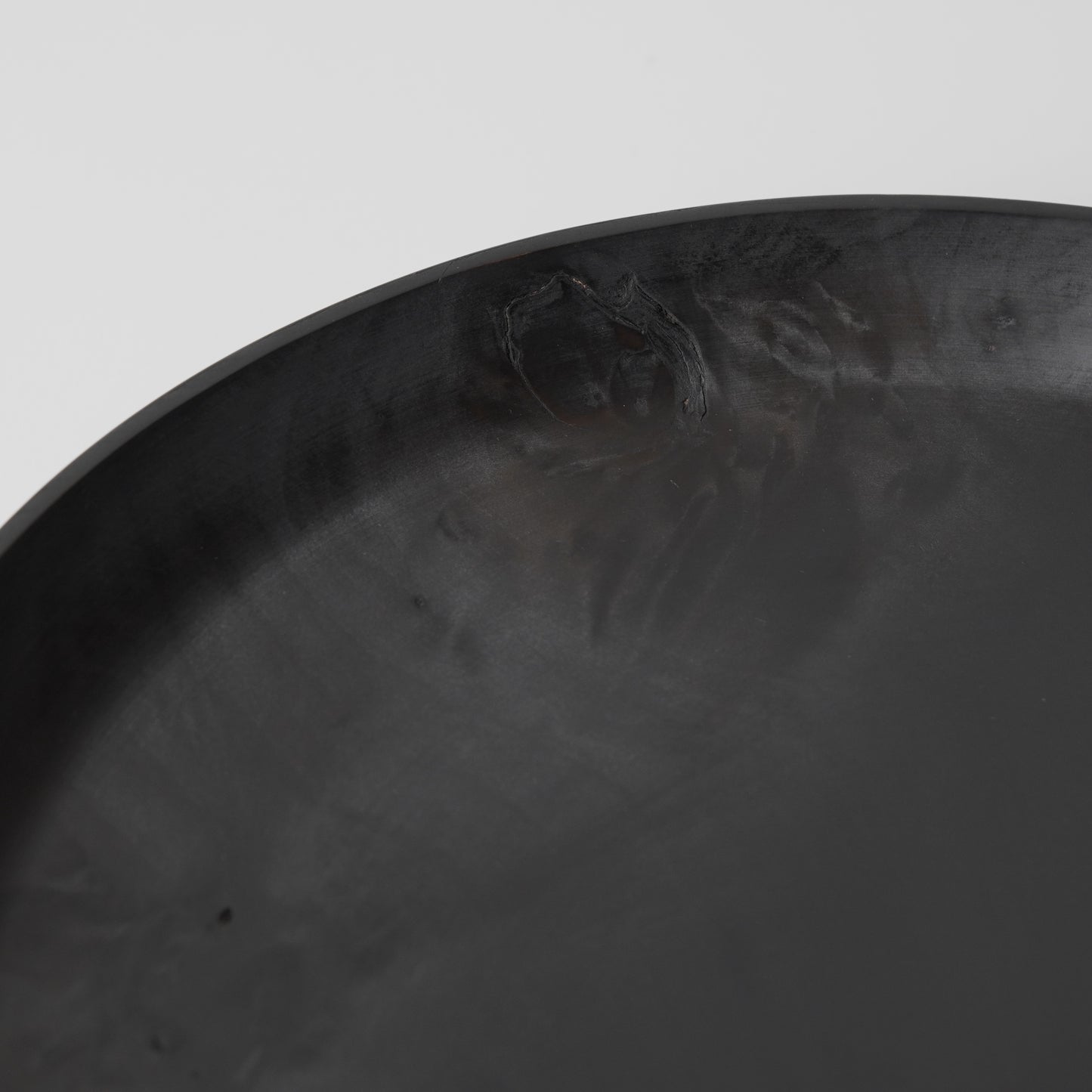 Close-up of a textured black surface with a white background