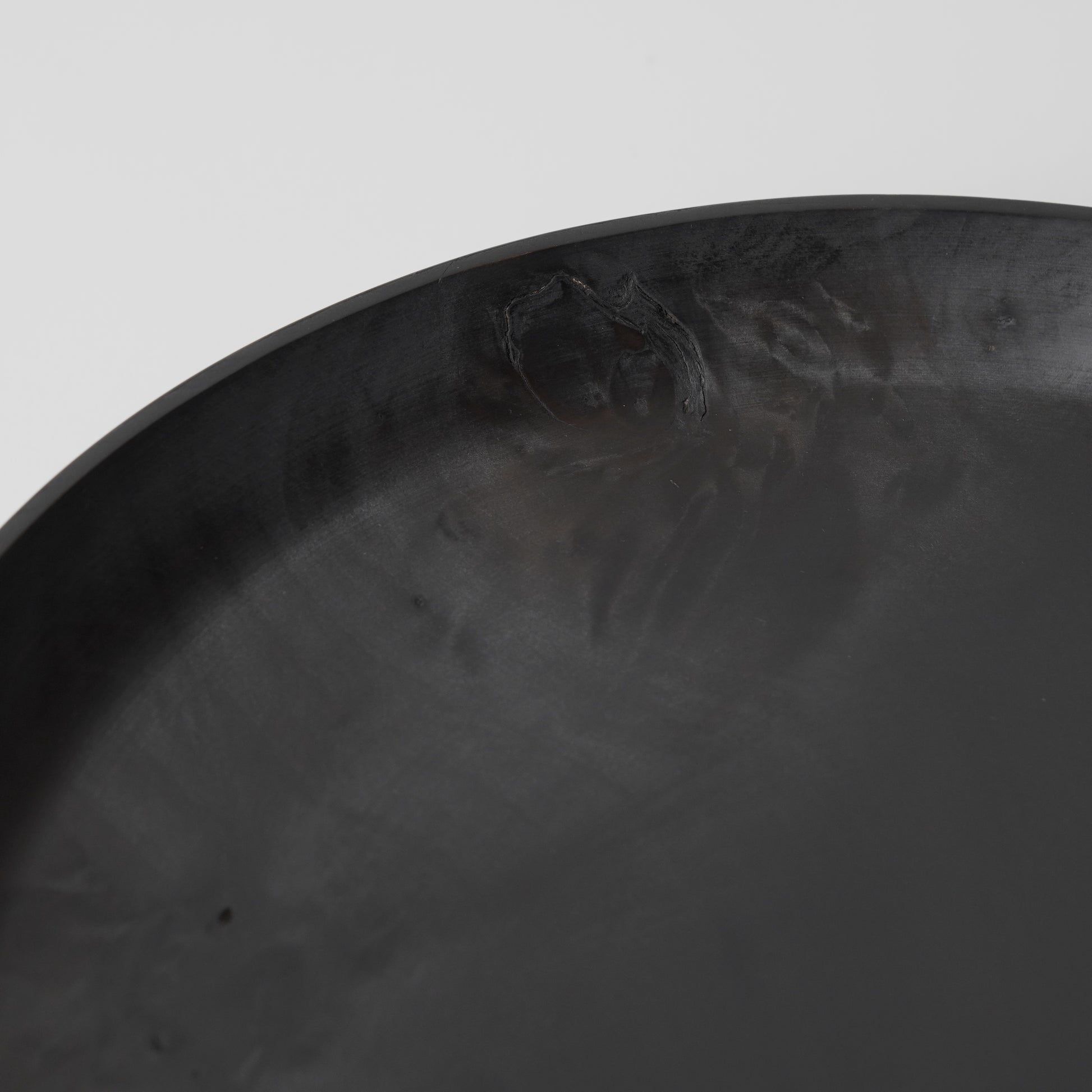 Close-up of a textured black surface with a white background
