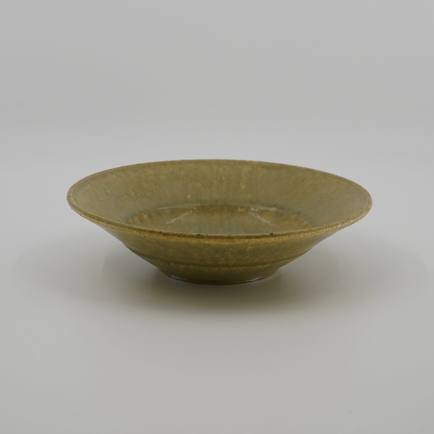 Green ceramic bowl on a white background