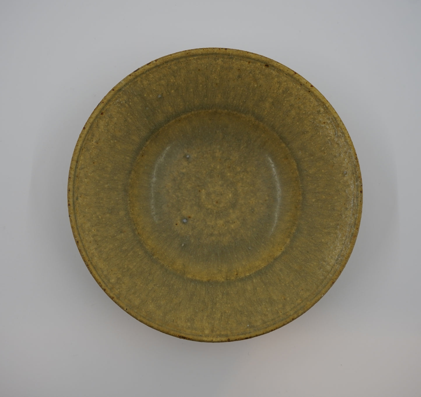 Green ceramic bowl on a gray background