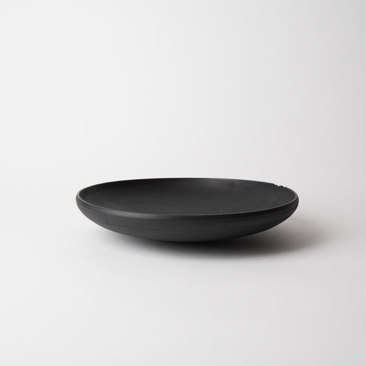 Black wooden bowl on a white background