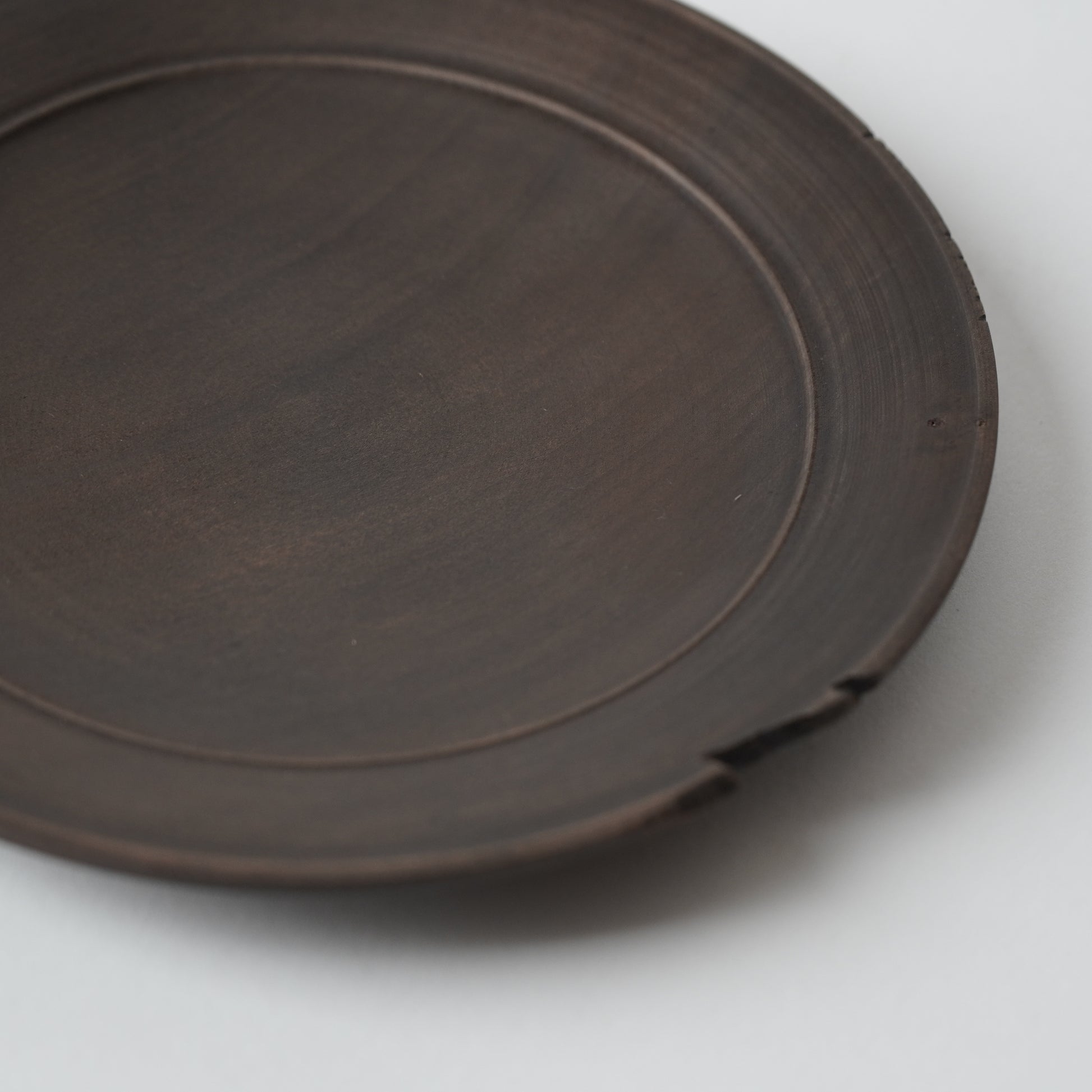 Brown wooden  plate on a white background