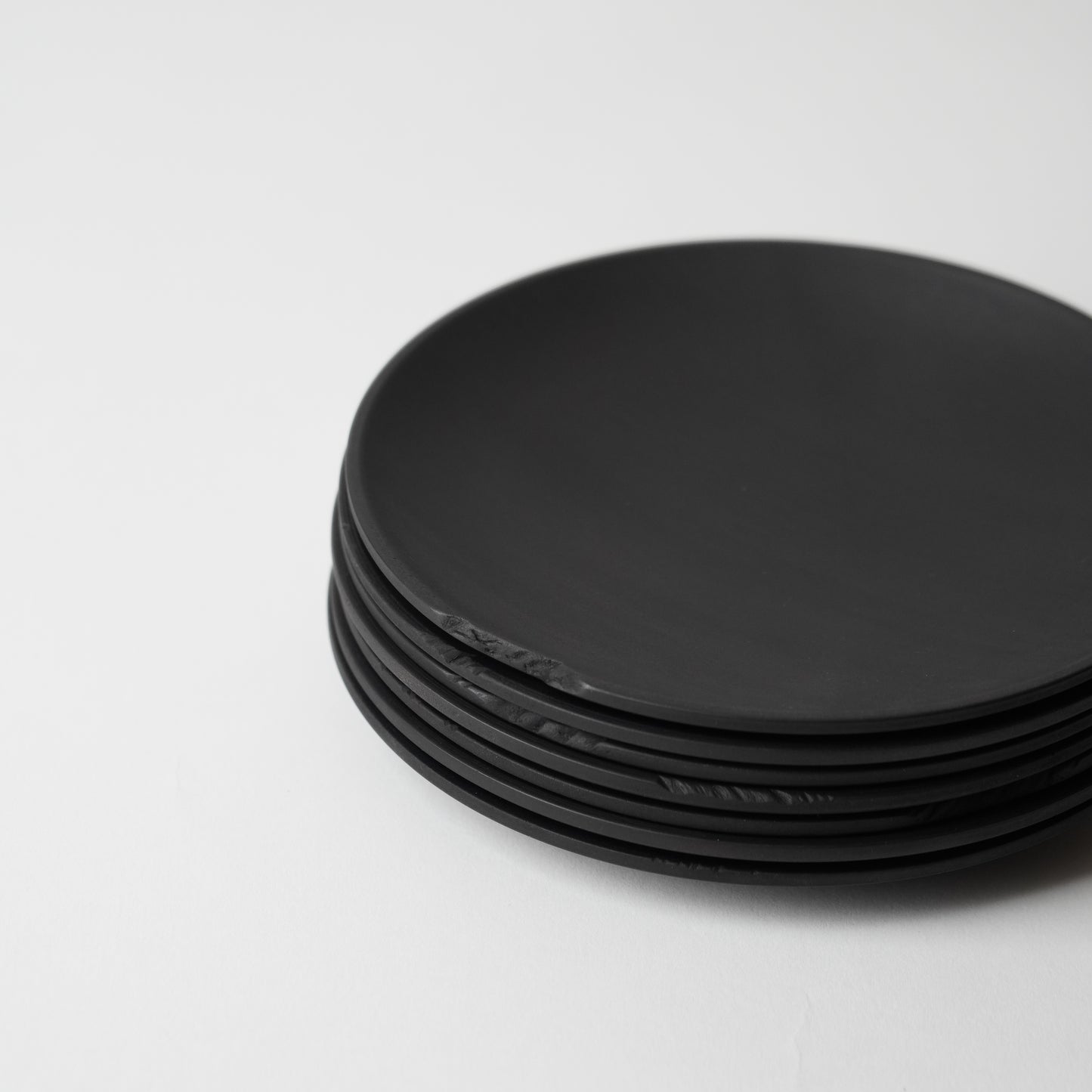 Stack of black round objects on a white background