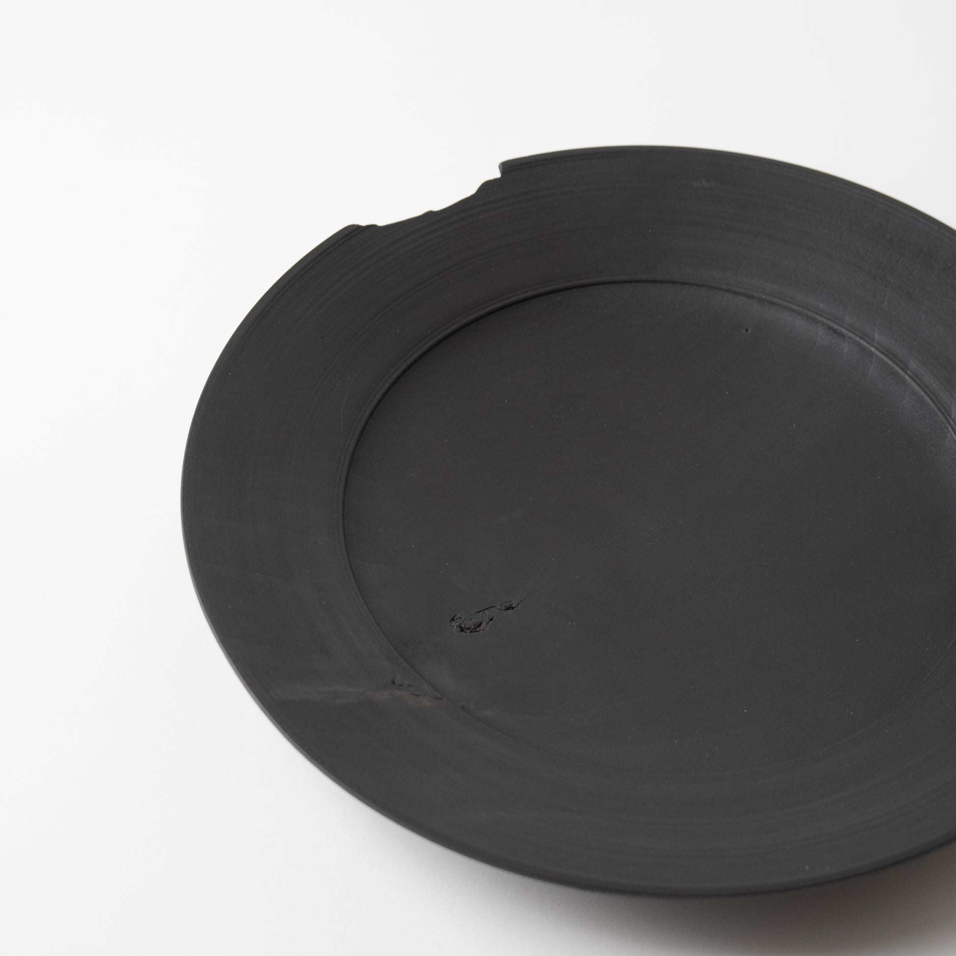 Black wooden plate on a white background