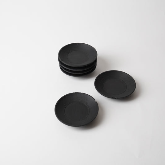 Set of black  wooden saucer on a white background. Handmade wooden saucer by Japanese artist at Gallery tete Hong Kong.