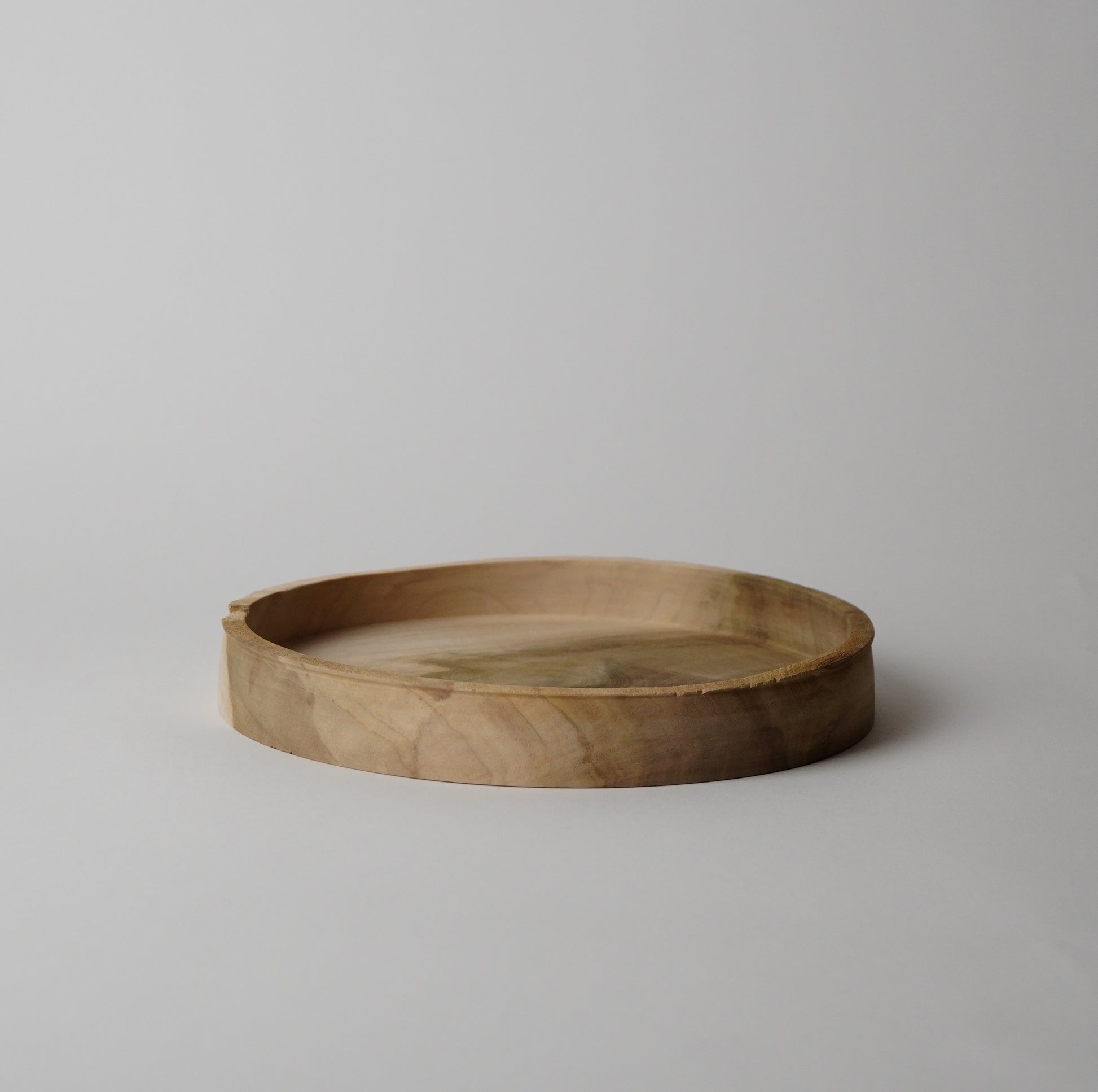 Wooden tray on a light gray background