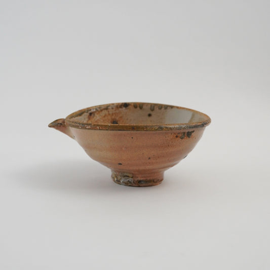 Ceramic bowl with brownish-red glaze on a white background