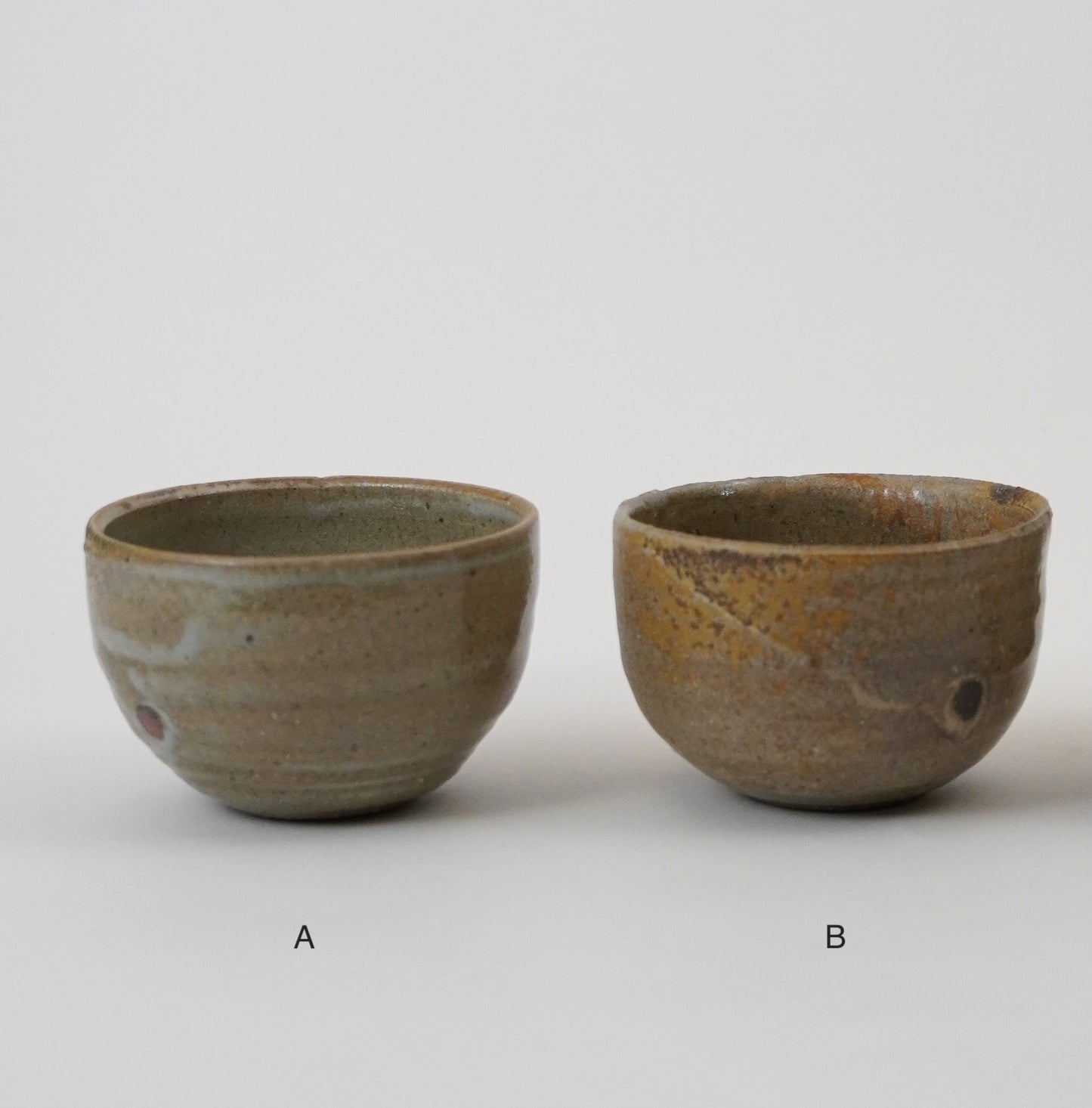 Two ceramic bowls labeled A and B on a plain background