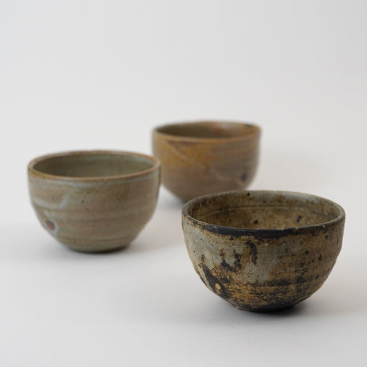 Three ceramic bowls with rustic textures on a white background