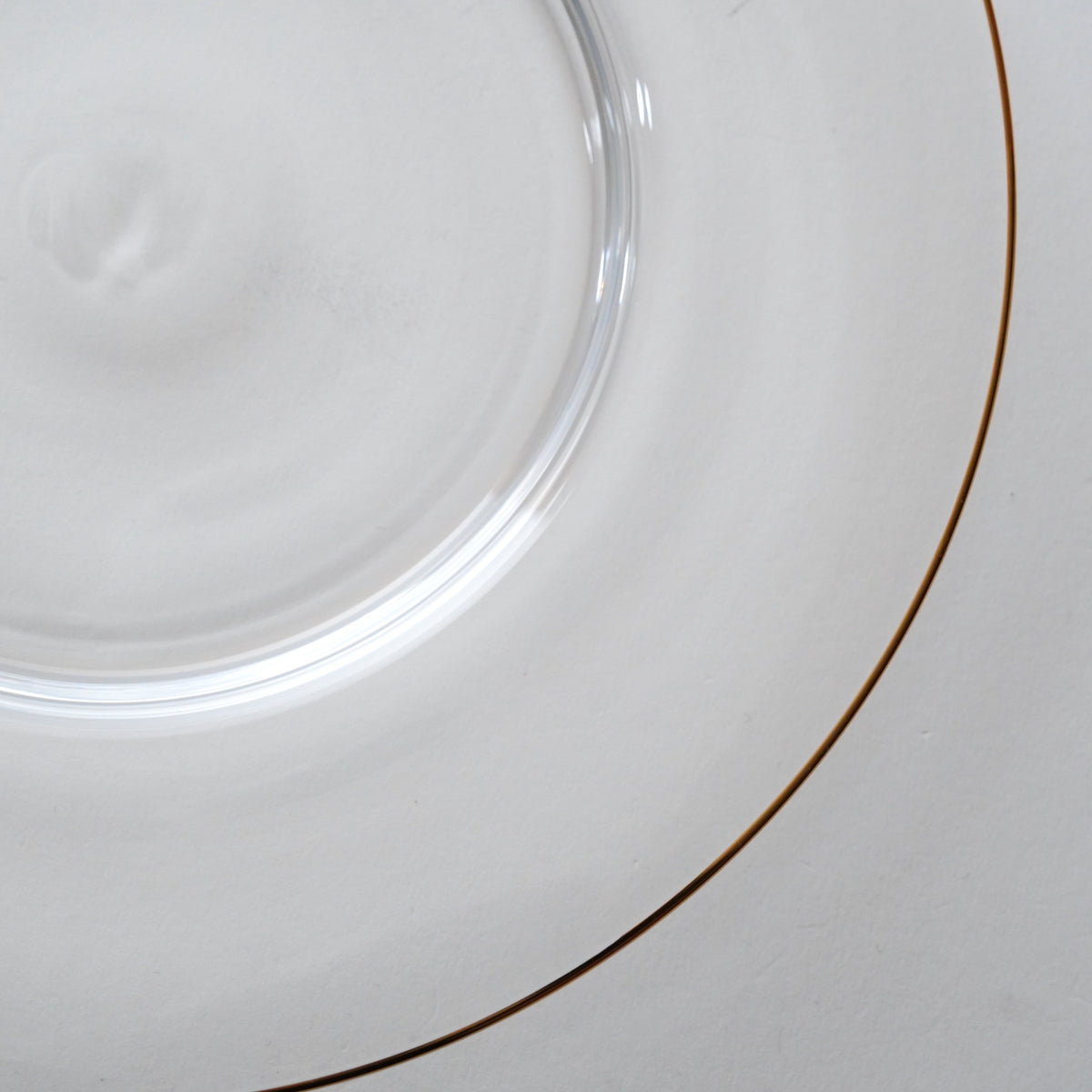 Close-up of a clear glass plate with a blurred background