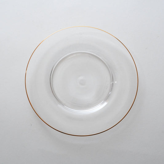 A clear glass plate with a golden rim.