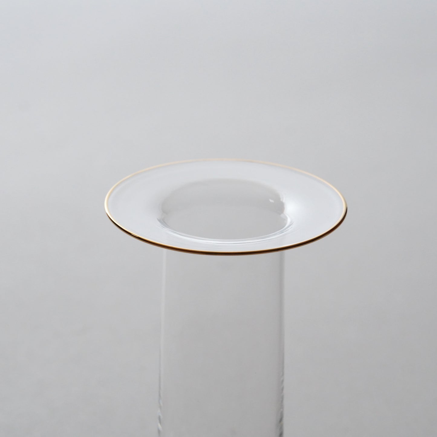White plate with gold rim on a white background