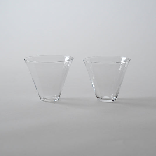 Two clear glass cold tea glasses placed side by side on a neutral background.