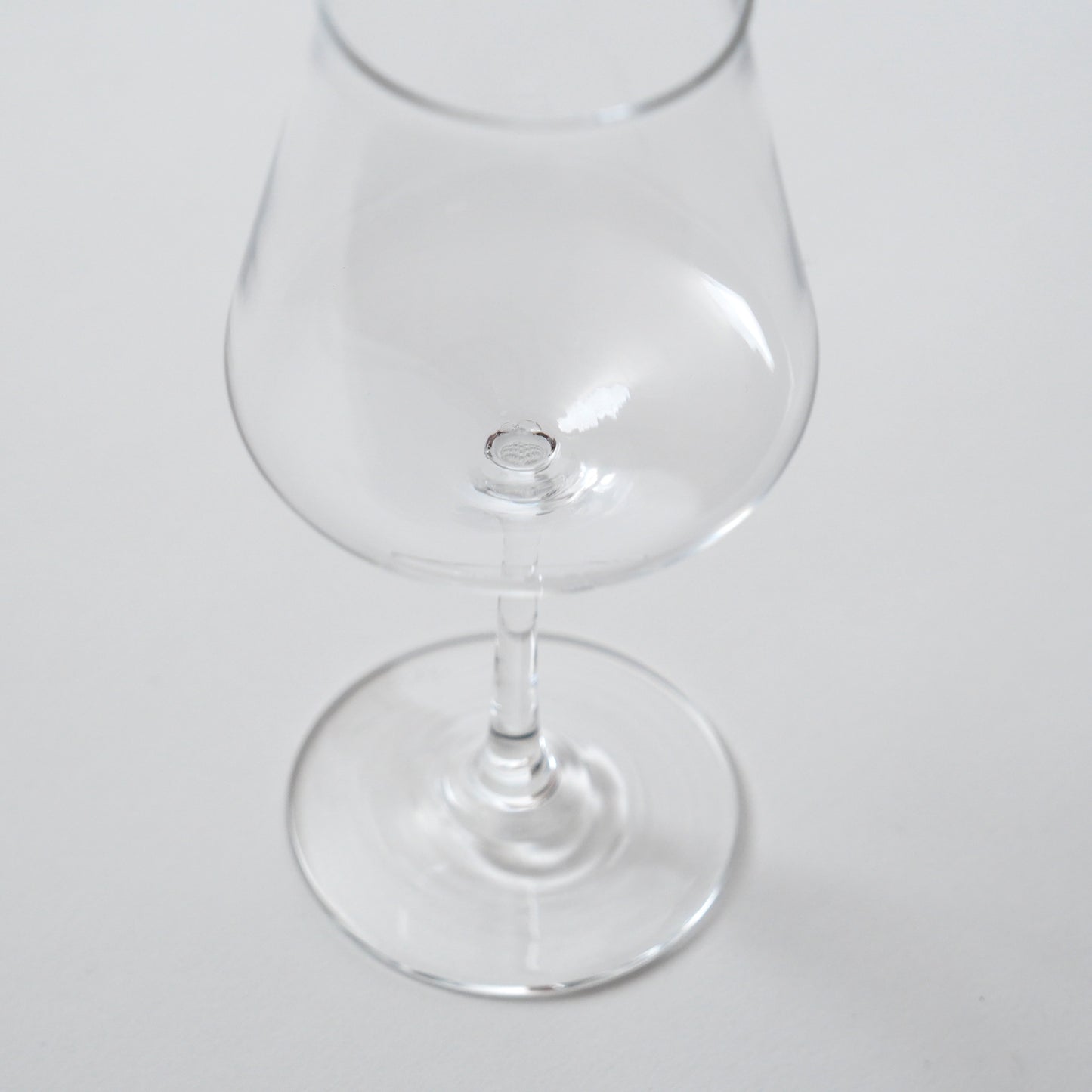 Clear glass snifter on a white background
