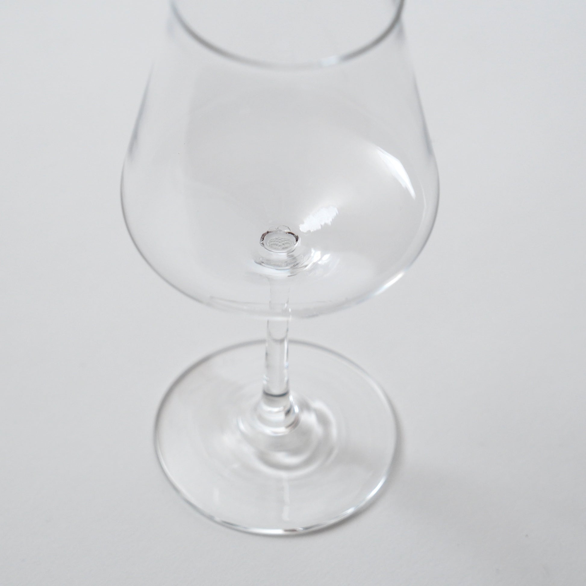 Clear glass snifter on a white background