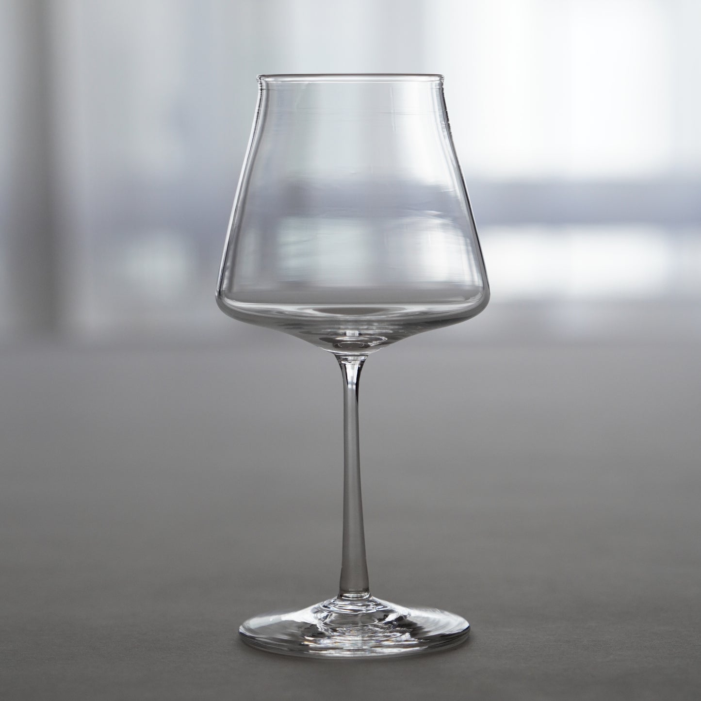 Clear wine glass on a neutral background